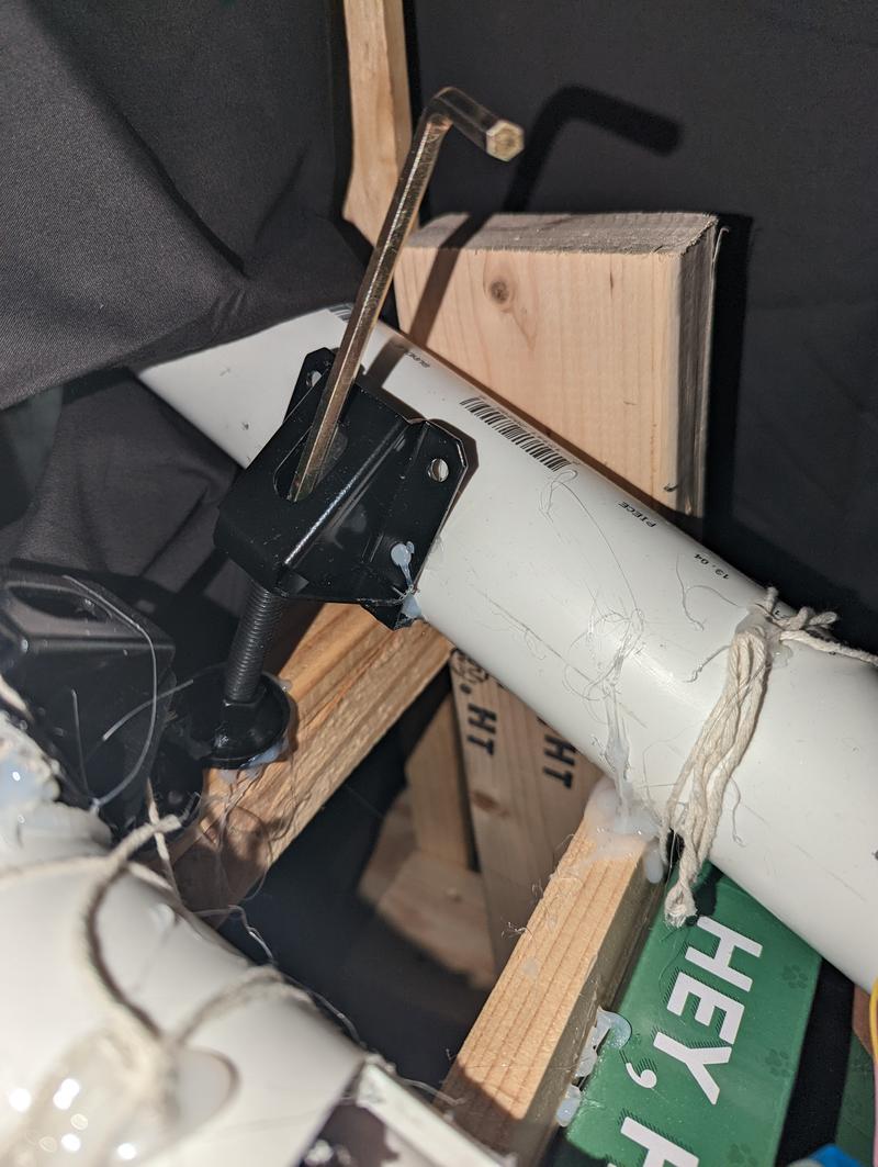 PVC pipe mounted on the furniture feet. The foot is glued to the side of the pipe with an extendible base extending downward. There is an allen wrench in the leg